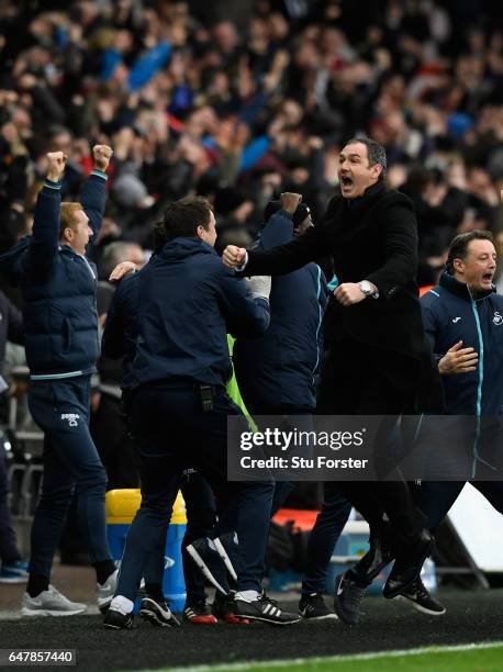 Swansea manager Paul Clement celebrates the winning goal with his staff during the Premier League match between Swansea City and Burnley at Liberty...