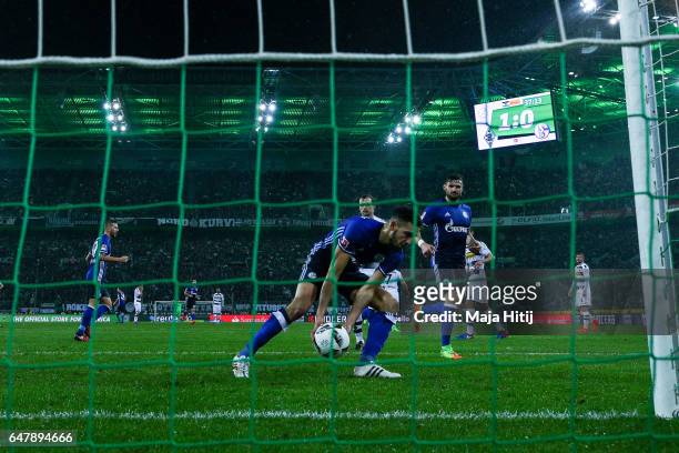 Nabil Bentaleb of Schalke holds the ball after scoring 11-meter penalty shot to make it 1-1 during the Bundesliga match between Borussia...