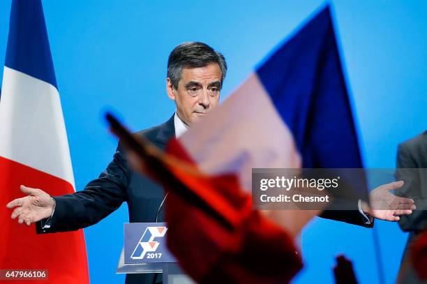 French presidential election candidate for the right-wing "Les Republicains" party Francois Fillon acknowledges the public after a campaign rally to...