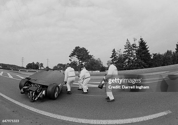 Circuit safety marshals come to the aid of Mark Webber of Australia as driving the AMG-Mercedes Mercedes-Benz CLR V8 becomes airborne over the hump...