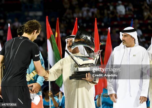 Andy Murray of Great Britain receives his trophy from Sheikh Hasher Bin Maktoum Al Maktoum, President of Tennis Emirates, after winning the final...
