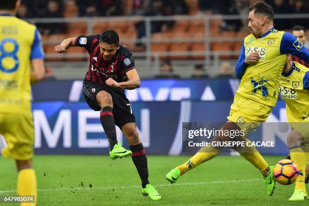 Milan's forward from Colombia Carlos Bacca kicks and scores during the Italian Serie A football match AC Milan vs Chievo at "San Siro" Stadium in...