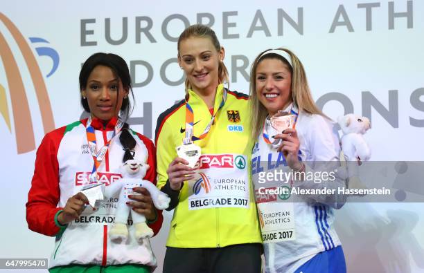 Silver medalist Patricia Mamona of Portugal, gold medalist Kristin Gierisch of Germany and bronze medalist Paraskevi Papahristou of Greece pose...