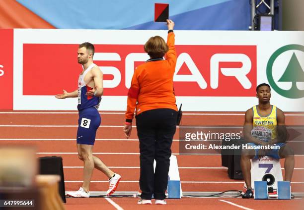 Andrew Robertson of Great Britain reacts as he is disqualified for a false start during the Men's 60 metres final on day two of the 2017 European...