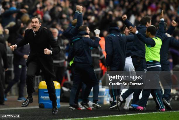 Swansea manager Paul Clement celebrates the winning goal by setting off on a run down the touchline during the Premier League match between Swansea...