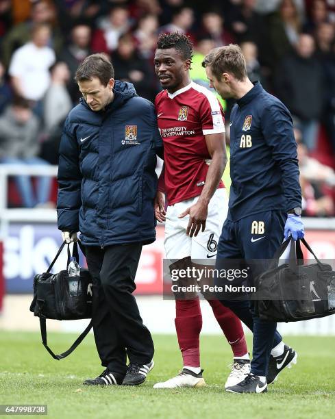 Gabriel Zakuani of Northampton Town leaves the pitch after recieving treatment after colliding with team mate Adam Smith causing Zakuani a leg injury...