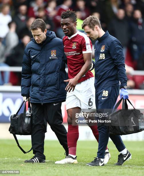 Gabriel Zakuani of Northampton Town leaves the pitch after recieving treatment after colliding with team mate Adam Smith causing Zakuani a leg injury...