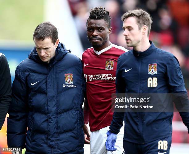 Gabriel Zakuani of Northampton Town leaves the pitch after recieving treatment after colliding with team mate Adam Smith causing Zakuani a leg injury...