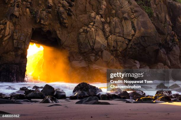 rugged keyhole rock arch at pfeiffer beach, ca, usa - glowing doorway stock pictures, royalty-free photos & images