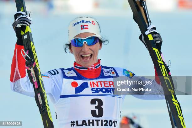 Marit Bjoergen from Norway celebrates after she wins Ladies cross-country 30 km Mass Start Free and her FOURTH GOLD MEDAL, at FIS Nordic World Ski...