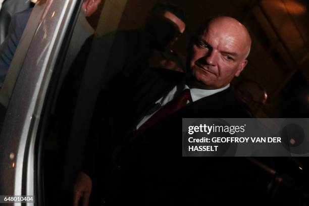 French far-right Front National party candidate for the presidential election Marine Le Pen's bodyguard Thierry Legier looks on as he is reflected in...