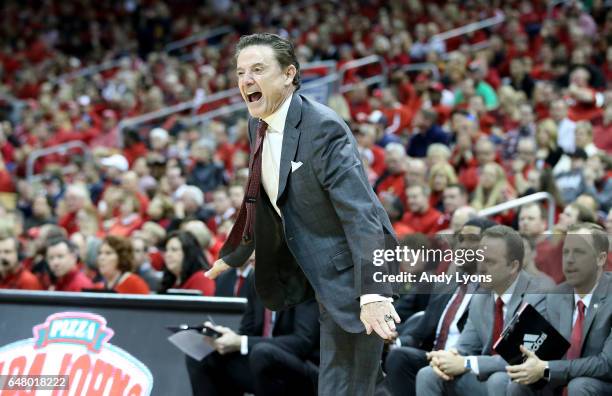 Rick Pitino the head coach of the Louisville Cardinals gives instructions to his team against the Notre Dame Fighting Irish at KFC YUM! Center on...