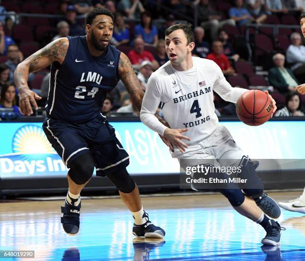 Nick Emery of the Brigham Young Cougars drives against Shamar Johnson of the Loyola Marymount Lions during a quarterfinal game of the West Coast...