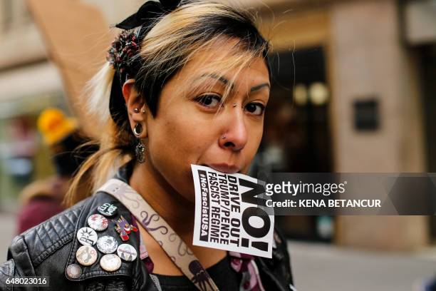 Woman holds a poster as she takes part of a protest against the planned Dakota Access Pipeline in North Dakota on March 04, 2017 in New York. / AFP...