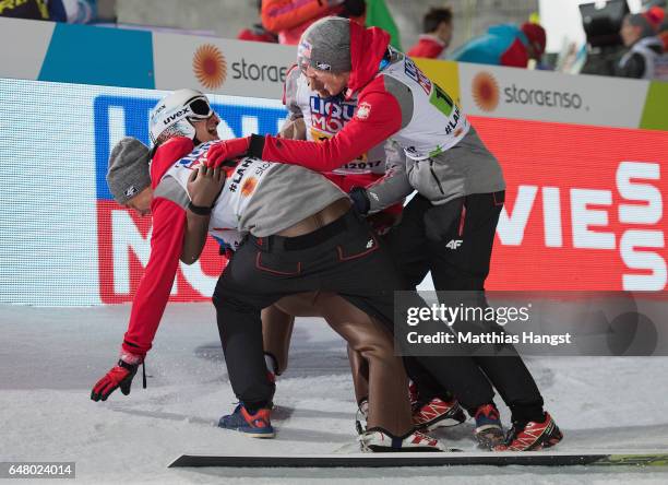 Kamil Stoch of Poland celebrates with his team-mates during the Men's Team Ski Jumping HS130 at the FIS Nordic World Ski Championships on March 4,...