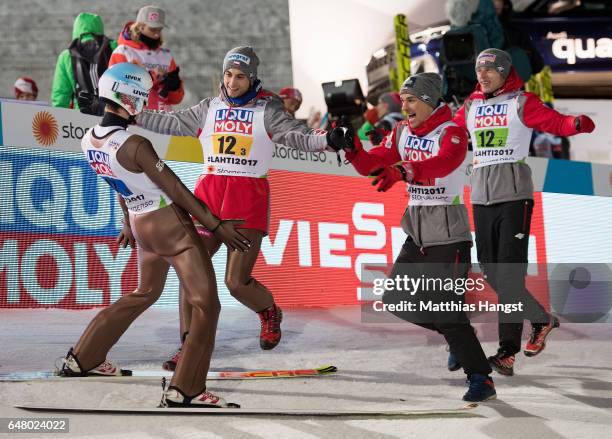 Kamil Stoch of Poland celebrates with his team-mates during the Men's Team Ski Jumping HS130 at the FIS Nordic World Ski Championships on March 4,...