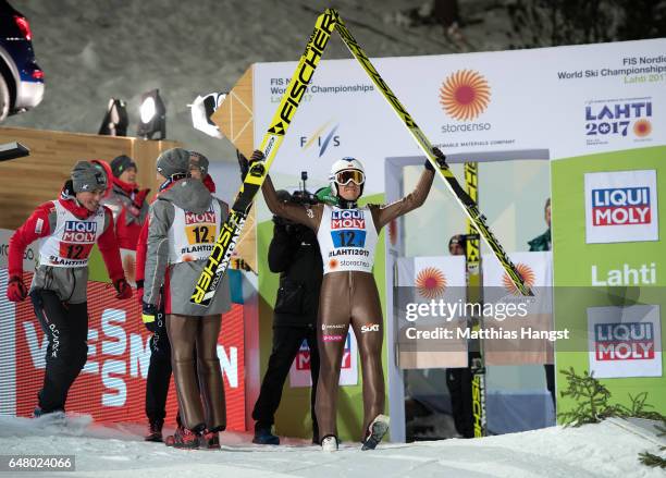 Kamil Stoch of Poland celebrates with his team-mates during the Men's Team Ski Jumping HS130 at the FIS Nordic World Ski Championships on March 4,...