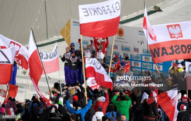 Kamil Stoch, Maciej Kot, David Kubacki and Piotr Zyla of Poland celebrate during the Men's Team Ski Jumping HS130 at the FIS Nordic World Ski...