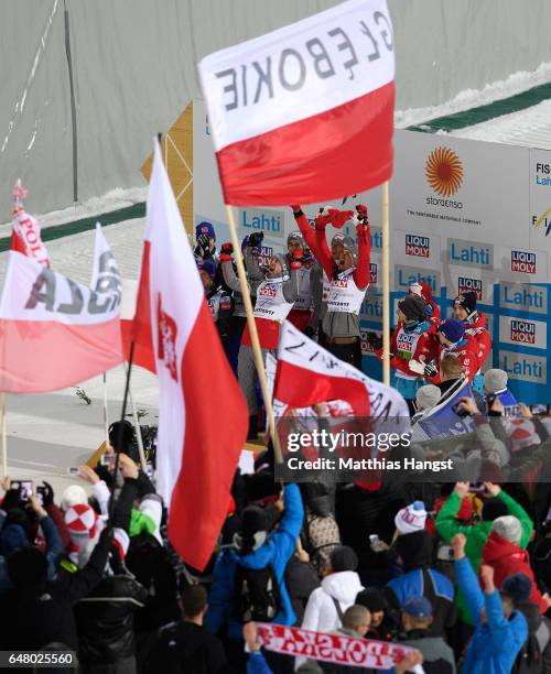 Kamil Stoch, Maciej Kot, David Kubacki and Piotr Zyla of Poland celebrate during the Men's Team Ski Jumping HS130 at the FIS Nordic World Ski...