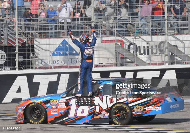 Victorious Kyle Busch Joe Gibbs Racing NOS Energy Toyota Camry salutes the crowd after winning the Xfinity Series Rinnai 250 on March 04 at Atlanta...