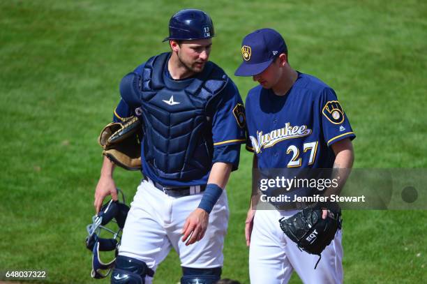 Andrew Susac and Zach Davies of the Milwaukee Brewers talk after closing out an inning against the Texas Rangers at Maryvale Baseball Park on March...