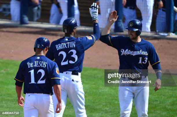 Keon Broxton of the Milwaukee Brewers is congratulated by Andrew Susac after hitting a three run home run in the fifth inning of the spring training...