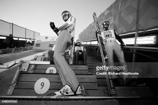 Stephan Leyhe of Germany and Manuel Fettner of Austria prepare to jump during the Men's Team Ski Jumping HS130 at the FIS Nordic World Ski...