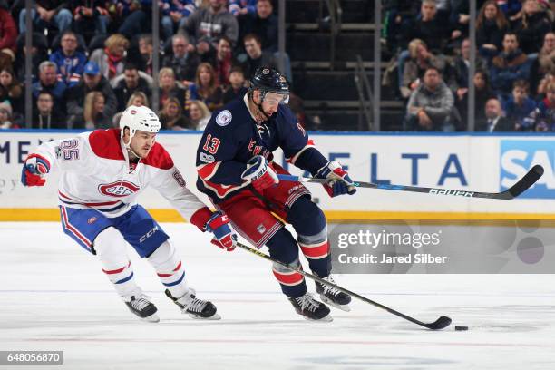 Kevin Hayes of the New York Rangers skates with the puck against Andrew Shaw of the Montreal Canadiens at Madison Square Garden on March 4, 2017 in...