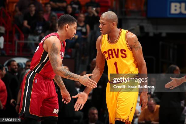 James Jones of the Cleveland Cavaliers shakes hands with Rodney McGruder of the Miami Heat before the game on March 4, 2017 at AmericanAirlines Arena...