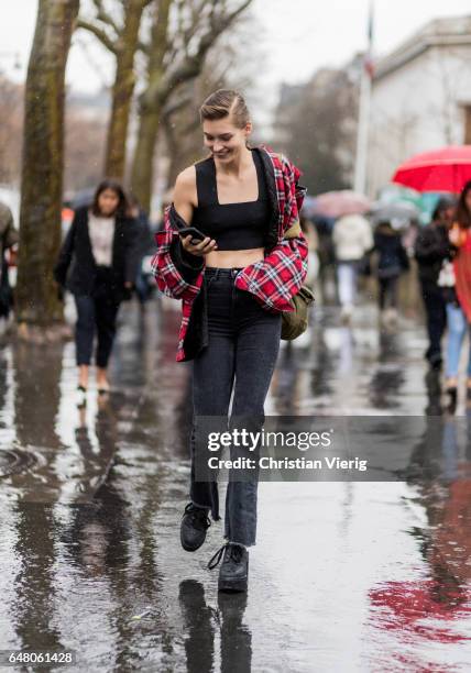 Model Grace Elizabeth wearing a cropped top, lumberjack jacket outside Mugler on March 4, 2017 in Paris, France.