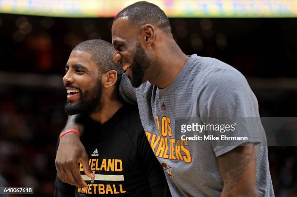 Kyrie Irving and LeBron James of the Cleveland Cavaliers laugh during a game against the Miami Heat at American Airlines Arena on March 4, 2017 in...