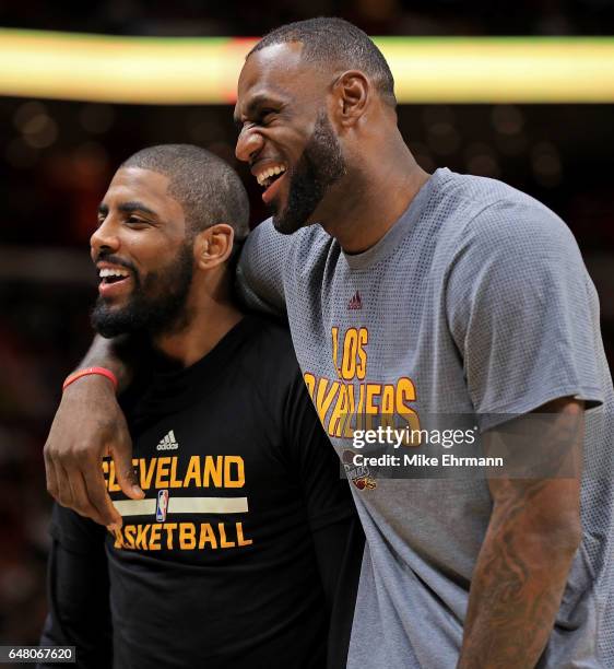 Kyrie Irving and LeBron James of the Cleveland Cavaliers laugh during a game against the Miami Heat at American Airlines Arena on March 4, 2017 in...