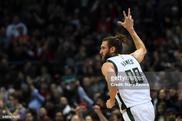 Spencer Hawes of the Milwaukee Bucks celebrates a three point shot during the first half of a game against the Toronto Raptors at the BMO Harris...