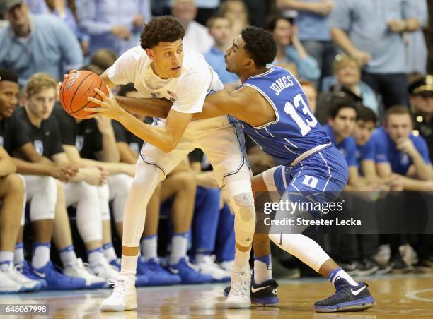 Matt Jones of the Duke Blue Devils tries to steal the ball from Justin Jackson of the North Carolina Tar Heels during their game at the Dean Smith...