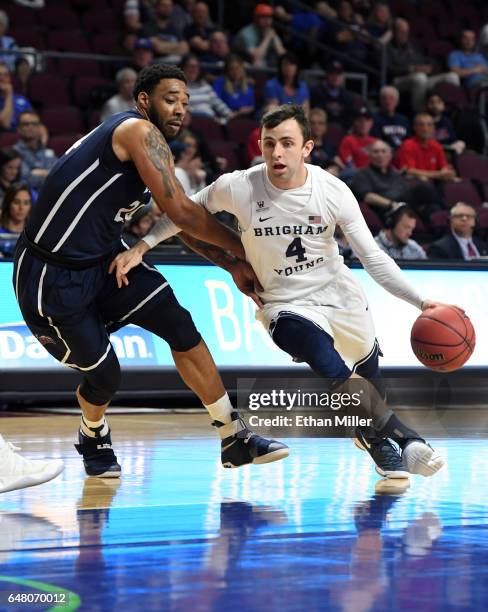 Nick Emery of the Brigham Young Cougars drives against Shamar Johnson of the Loyola Marymount Lions during a quarterfinal game of the West Coast...