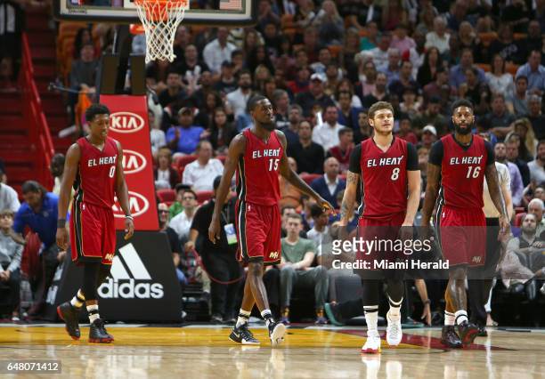 Miami Heat player Josh Richardson, Okaro White, Tyler Johnson and James Johnson walk to the bench during the first quarter of an NBA basketball game...