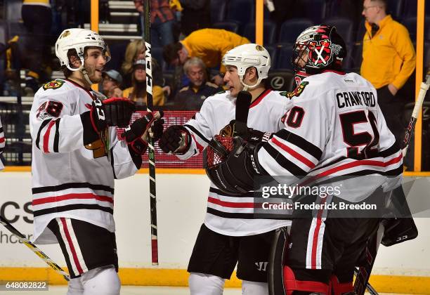 Ryan Hartman, and Jordin Tootoo, of the Chicago Blackhawks congratulate goalie Corey Crawford on a 5-3 victory over of the Nashville Predators at...