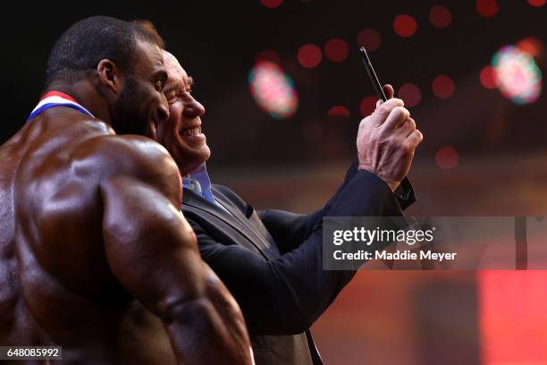 Arnold Schwarzenegger takes a selfie with Arnold Classic winner Cedric McMillan at the Greater Columbus Convention Center during the Arnold Sports...