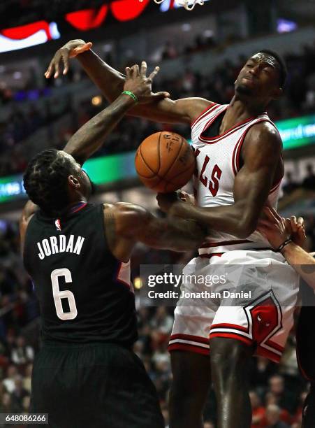 DeAndre Jordan of the LA Clippers knocks the ball away from Bobby Portis of the Chicago Bulls at the United Center on March 4, 2017 in Chicago,...