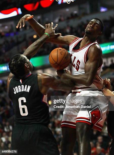 DeAndre Jordan of the LA Clippers knocks the ball away from Bobby Portis of the Chicago Bulls at the United Center on March 4, 2017 in Chicago,...