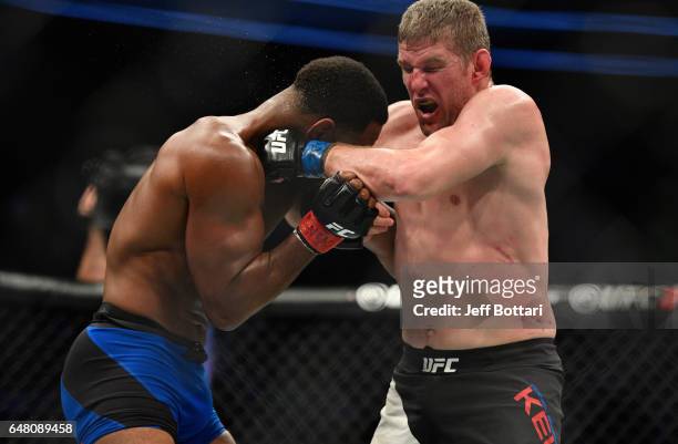 Daniel Kelly of Australia punches Rashad Evans in their middleweight bout during the UFC 209 event at T-Mobile Arena on March 4, 2017 in Las Vegas,...