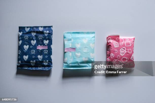 sanitary towels in coloured wraps - sports period stock pictures, royalty-free photos & images
