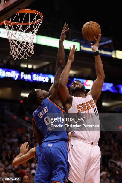 Alan Williams of the Phoenix Suns attempts a shot against Jerami Grant of the Oklahoma City Thunder during the second half of the NBA game at Talking...
