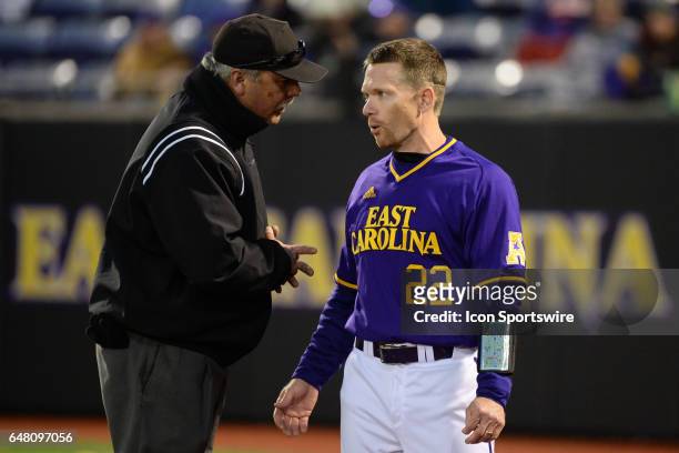 East Carolina assistant coach Jeff Palumbo talks with third base Umpire in a game between the St. John"s Red Storm and the East Carolina Pirates...