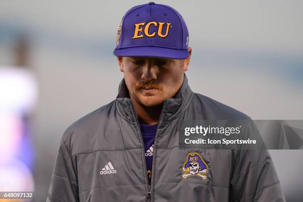 East Carolina assistant coach Parker Lamm walks back to the dugout in a game between the St. John"s Red Storm and the East Carolina Pirates during...