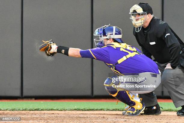 East Carolina catcher Travis Watkins catches a pitch in a game between the St. John"s Red Storm and the East Carolina Pirates during the Keith...