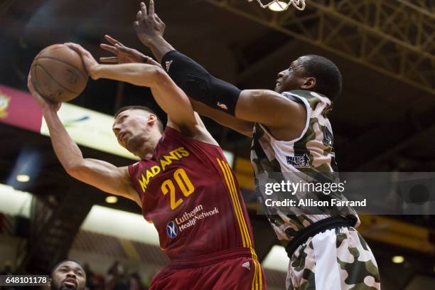 Jarrod Uthoff of the Fort Wayne Mad Ants and Jonathan Holmes of the Canton Charge fight for a rebound at the Canton Memorial Civic Center on March 4,...