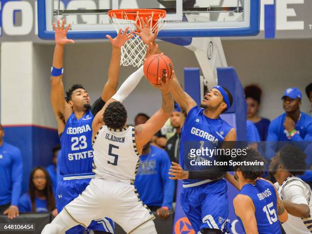 Georgia Southern's BJ Gladden attempts a shot over Georgia State's Jordan Session and Jeremy Hollowell in a Sun Belt Conference basketball game at...