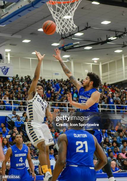 Georgia Southern's Tookie Brown shoots over Georgia State defender Demarcus Simonds in a Sun Belt Conference basketball game at the GSU Sports Arena...