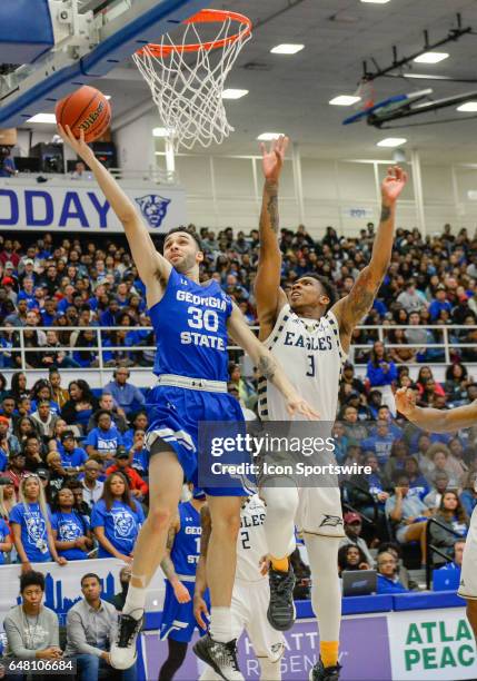 Georgia State's Jeff Thomas drives to the basket against Georgia Southern's Ike Smith in a Sun Belt Conference basketball game at the GSU Sports...